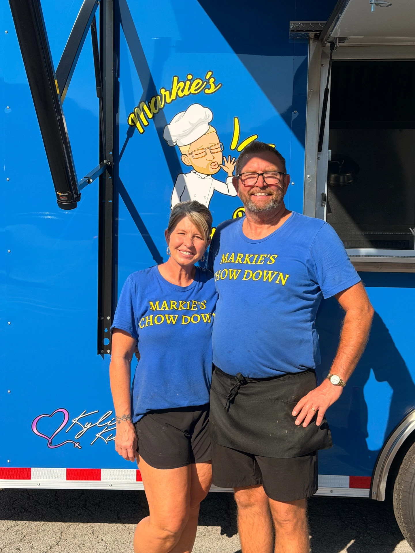Markie and Tonya standing in front of the Markie's Chow Down food truck